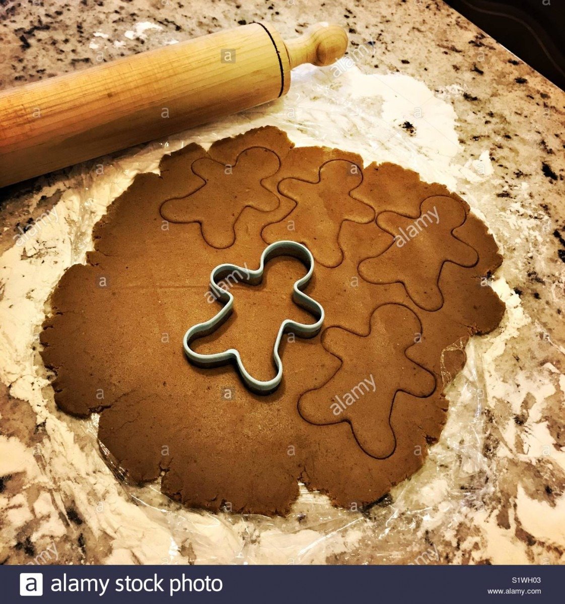 Gingerbread Cookie Dough Is Rolled Out On A Marble Counter With A
