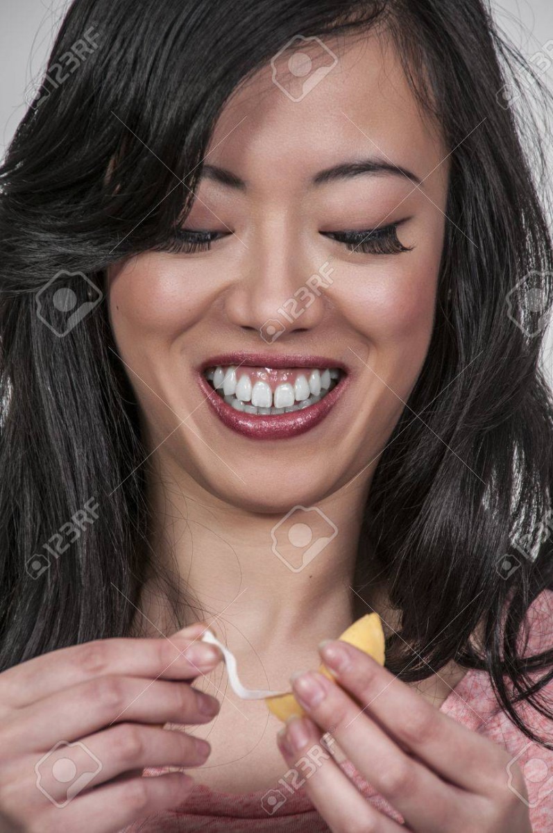 Beautiful Asian Woman Reading A Fortune Cookie Note Stock Photo