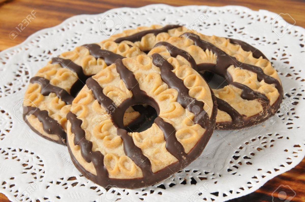 A Stack Of Chocolate Fudge Striped Shortbread Cookies On A Doily